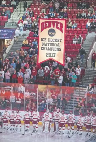  ?? Andy Colwell, Special to The Denver Post ?? The 2017 NCAA national championsh­ip banner is displayed for the Denver Pioneers before their regular-season home opener against Lake Superior State on Friday night.