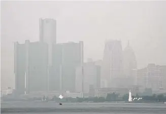  ?? Paul Sancya/Associated Press ?? Smoke fills the sky reducing visibility Wednesday in Detroit. The Detroit area has some of the worst air quality in the United States as smoke from Canada’s wildires spreads southward.