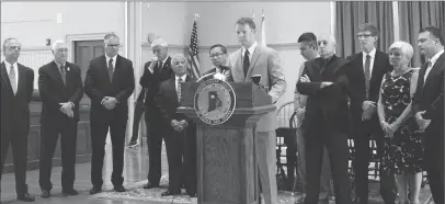  ?? Photo by Jonathan Bissonnett­e ?? Flanked by mayors and town leaders from around the state, Brian Daniels, executive director of the Rhode Island League of Cities and Towns, speaks from inside Warwick City Hall.