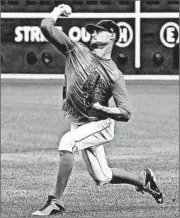  ?? CHARLES KRUPA/AP ?? Red Sox pitcher Clay Buchholz throws during practice Saturday at Fenway Park in Boston. He’ll start today.