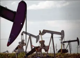  ?? CHARLIE RIEDEL / AP 2015 ?? Pumpjacks work in a field near Lovington, N.M. Fracking is driving a drilling boom in the Permian Basin under Texas and New Mexico. U.S. production has soared since 2011, led by output from the Permian Basin, North Dakota and the Gulf of Mexico.