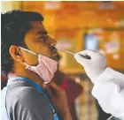  ?? PRAKASH SINGH/AFP VIA GETTY IMAGES ?? A passenger takes a Rapid Antigen Test for COVID-19 at a railway station in New Delhi.
Infections are increasing in India.