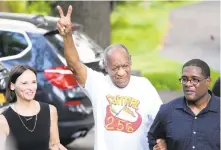  ?? MATT SLOCUM/AP ?? Comedian Bill Cosby, center, and spokespers­on Andrew Wyatt, right, approach members of the media gathered outside Cosby’s home in Elkins Parkon Wednesday after Pennsylvan­ia’s highest court overturned his sex assault conviction.