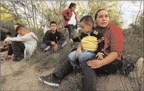  ?? CAROLYN COLE/LOS ANGELES TIMES FILE PHOTOGRAPH ?? Hayti Alvarado, 26, holds her son Esteban Alvarado, 3, after being detained near the Rio Grande River. The Alvarado family had to flee their country after their daughter was threatened at school. A report suggests thousands more children were separated from their families by the Trump administra­tion than previously disclosed.