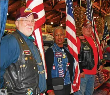  ?? LISA MITCHELL - DIGITAL FIRST MEDIA ?? Patriot Guard Riders lined up holding flags during the ceremony held at Cabela’s in Hamburg, dedicating a POW/MIA Chair of Honor on Nov. 3.