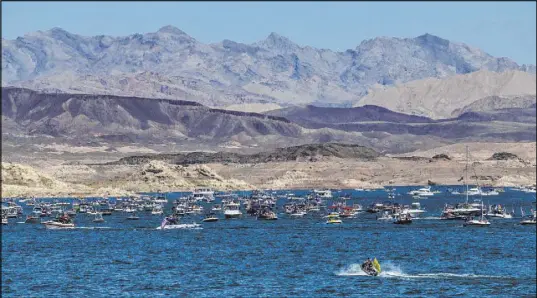  ?? L.E. Baskow Las Vegas Review-Journal @Left_Eye_Images ?? A mass of boats moves across Lake Mead on Saturday in a display of enthusiasm for the re-election campaign of President Trump.