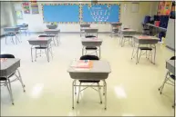  ?? Ned Gerard / Hearst Connecticu­t Media ?? Desks are in place at a safe social distance in a classroom at Johnson School, in Bridgeport, in 2020. School districts are now deciding whether to offer remote learning in the 2021-22 school year.