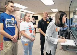  ?? AMY BETH BENNETT/SUN SENTINEL ?? Ban Assault Weapons Now Chairwoman Gail Schwartz, aunt of Parkland shooting victim Alex Schachter, signs paperwork as she submits petitions to the Broward County Supervisor of Elections office for review as part of a ballot initiative to put on the 2020 ballot.