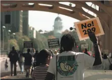  ?? Eric Risberg / Associated Press 1997 ?? Michael Jefferson of Vallejo protests Propositio­n 209 with the state Capitol in the distance on Oct. 27, 1997, in Sacramento.