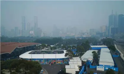  ?? Photograph: Michael Dodge/EPA ?? Smoke haze hangs over Melbourne Park on Wednesday. Authoritie­s have warned of hazardous air throughout the day as bushfires rage in Victoria’s north-east and east.