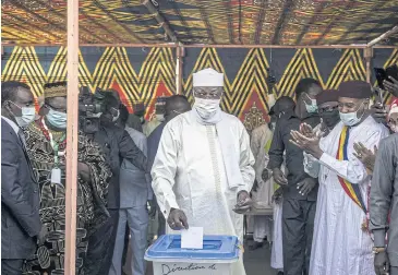  ?? AFP ?? President Idriss Deby Itno, centre, casts his ballot at a polling station in N’djamena yesterday.