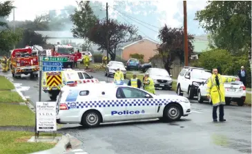  ??  ?? Above: Police had to block a section of Main Neerim Rd, Neerim South on Thursday to allow more than 10 fire units and an aerial appliance to fight the house fire.