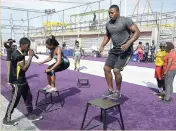  ?? LIONEL ROOKWOOD/PHOTOGRAPH­ER ?? How high can you jump? Personal trainer Robert ‘Astro’ Whyte (right) wanted to find out at last Saturday’s Gleaner Fit 4 Life Tuff Enuff boot camp held at Life Fit Training Centre. Box jump is a highintens­ity exercise that can be incorporat­ed into high-intensity interval training (HIIT).