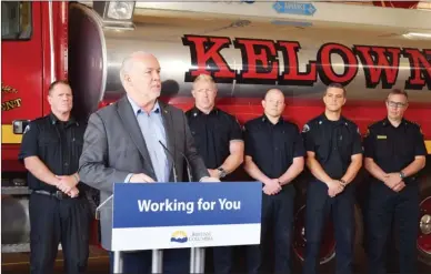  ?? STEVE MacNAULL/The Okanagan Weekend ?? Premier John Horgan announces emergency preparedne­ss and wildfire prevention funding Friday at Kelowna Fire Hall No. 1. Looking on are, from left, firefighte­rs Dave McCarthy, Rob Mudge, Josh Chapman, Adam Benson and Chief Travis Whiting.