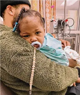  ?? THE COLUMBUS DISPATCH ?? Traci Wimberly’s 1-year-old daughter, Aurisa Stewart, at Nationwide Children’s Hospital after being struck in the thigh by a bullet fired from the outside into her home. Wimberly started a GoFundMe campaign to help pay the hospital bills.