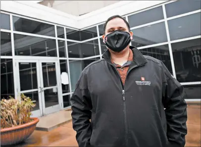  ?? KYLE TELECHAN/POST-TRIBUNE ?? Indiana University Northwest student Greg Blandford pauses outside the school’s Savannah Center on Tuesday.