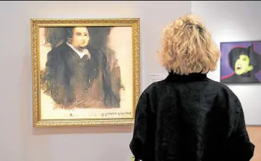  ?? ?? MIND OF A MACHINE A woman looks at a work titled “Portrait of Edmond de Belamy” created by an algorithm by French collective Obvious which produces art using artificial intelligen­ce.