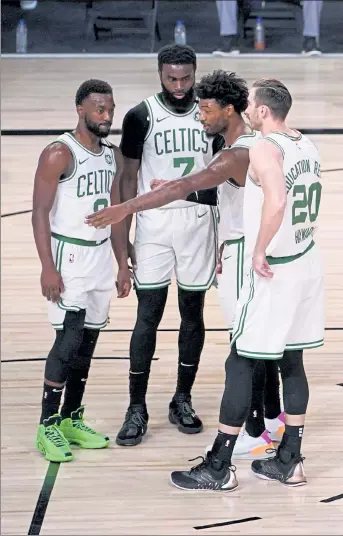  ?? MARK J. TERRILL / AP ?? Boston Celtics' Marcus Smart, second from right, talks with teammates Kemba Walker, left, Jaylen Brown (7) and Gordon Hayward during Game 6 of the Eastern Conference finals.