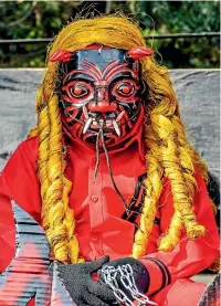  ??  ?? A local dressed as a devil in a parade near Antigua, Guatemala.