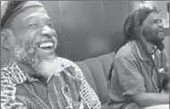  ?? CHERYL HATCH/AP FILE ?? Musician Cedric Brooks, left, laughs next to Johnny Moore as they talk about their days at the Alpha Boys School in Kingston, Jamaica.