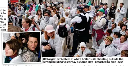  ??  ?? Off target: Protesters in white boiler suits chanting outside the wrong building yesterday as some (left) resorted to bike locks