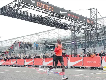 ?? LUCA BRUNO/THE ASSOCIATED PRESS ?? Olympic marathon champion Eliud Kipchoge crosses the finish line at the Monza Formula One racetrack in Italy earlier this month with a time of two hours and 25 seconds. Nike is leading a push for a two-hour marathon.