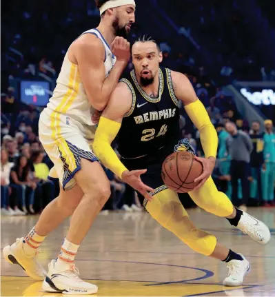  ?? JOE RONDONE/THE COMMERCIAL APPEAL ?? Grizzlies guard Dillon Brooks drives past Warriors guard Klay Thompson during Game 4 of the second round of the NBA playoffs on Monday at Chase Center.