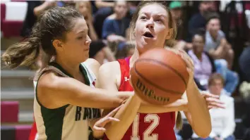  ?? JULIE JOCSAK/POSTMEDIA NETWORK ?? Amanda Hemphill of the Holy Cross Raiders tries to get the ball away from Emily White of the Denis Morris Reds during the Standard Girls Basketball Tournament at Governor Simcoe Thursday. Denis Morris Reds defeated Holy Cross 43-18.