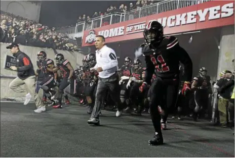  ?? JAY LAPRETE — ASSOCIATED PRESS ?? Ohio State coach Urban Meyer leads his team on to the field before their game against Penn State on Oct. 17 in Columbus.