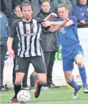  ??  ?? Armed combat Paul Burns, right, battles for the ball