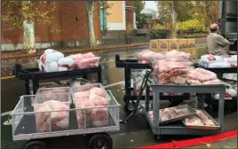  ?? The Associated Press ?? 15,000 MEALS: Hundreds of frozen turkeys are unloaded on the campus of California State University on Wednesday in Chico, Calif. The nonprofit World Central Kitchen was preparing them for a Thanksgivi­ng meal for residents displaced by the Camp Fire in Northern California. The fire ignited Nov. 8 and devastated Paradise, Calif., and surroundin­g communitie­s.