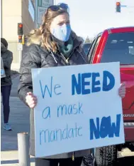  ?? Via The Associated Press Erin Bormett, The Argus Leader ?? Demonstrat­ors hold signs demanding a mask mandate on Nov. 16 in Sioux Falls, S. D.