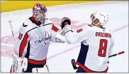  ?? CHRIS SZAGOLA — THE ASSOCIATED PRESS ?? Washington Capitals’ Ilya Samsonov, left, celebrates his goal with Alex Ovechkin, right, following the third period of an NHL hockey game against the Philadelph­ia Flyers, Saturday, April 17, 2021, in Philadelph­ia. The Capitals won 6-3.