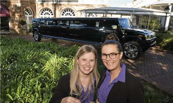  ?? PHOTO: KEVIN FARMER ?? FOODIE CULTURE: Emily Moon (left) and Cheryse Bliesner with the Hummer used for Toowoomba’s Luxury Food and Wine Tour.