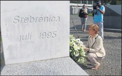  ??  ?? Rememberin­g all those who died...laying flowers during a “deeply moving” visit to the Memorial Centre in Srebrenica