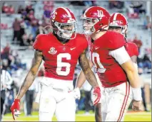  ?? Gary Cosby Jr. The Associated Press ?? Alabama wide receiver Devonta Smith, left, and quarterbac­k Mac Jones celebrate a touchdown Oct. 31. They are among the Crimson Tide’s three finalists for the Heisman Trophy.