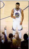  ?? AP/BEN MARGOT ?? Golden State guard Stephen Curry celebrates Thursday as fans cheer his three-pointer to end the first half of the Warriors’ 124-114 overtime victory over the Cleveland Cavaliers in Game 1 of the NBA Finals in Oakland, Calif.