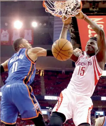  ?? — AP ?? Houston Rockets’ Clint Capela (15) dunks as Oklahoma City Thunder’s Russell Westbrook (left) defends during Game 5 of the NBA first-round playoffs in Houston on Tuesday. The Rockets won 105-99.