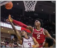  ?? (AP/College Station Eagle/Michael Miller) ?? Texas A&M’s Quenton Jackson (3) shoots as Adrio Bailey of Arkansas defends Saturday in College Station, Texas. Jackson had 14 points as Texas A&M won 77-69.