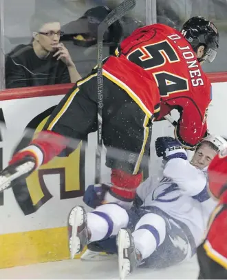  ?? Ted Rhodes/calgary Herald ?? Flames right winger David Jones slams into Tampa Bay Lightning defender Matthew Carle in the Lightning zone during the first period Friday at the Saddledome.