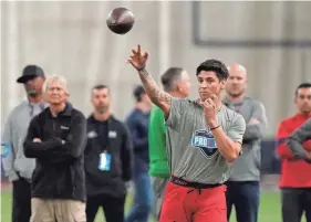  ?? AP ?? Quarterbac­k Matt Corral throws a pass during a drill at the Mississipp­i football pro day on March 23 in Oxford, Miss.