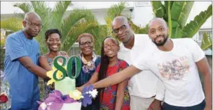  ??  ?? Mrs Eno-Edet Traore (3rd left) cutting her birthday cake with children and grandchild­ren