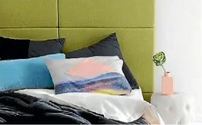  ??  ?? The headboard is covered in Warwick Lindeman fabric in Lime and an Adele ottoman from Freedom is used as a bedside table.