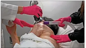  ?? ?? Last operation...medics perform the final laser surgery on Kim’s scar tissue