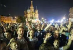  ?? ASSOCIATED PRESS ?? France’s soccer fans sing their national anthem in Red Square, with the St. Basil’s Cathedral in the background, after France won the final match between France and Croatia at the 2018 soccer World Cup in the Luzhniki Stadium in Moscow Sunday.