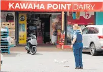  ?? Photos / Ben Fraser, Laura Smith ?? Above: Police outside Kawaha Point Dairy on Tuesday afternoon.
Left: Kawaha Point Dairy and Liquor Centre owner Harshminde­r Singh shows the injuries he recieved from an alleged robber.