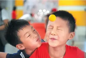  ?? ZHANG YAZI / CHINA NEWS SERVICE ?? Children play a game at the Hefei Science and Technology Museum during a summer camp organized by Sanshitou Community in Hefei, Anhui province, on Thursday.