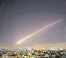  ?? AP PHOTO ?? The Damascus sky lights up with missile fire as the US, the UK and France launch an attack on Syrian targets.