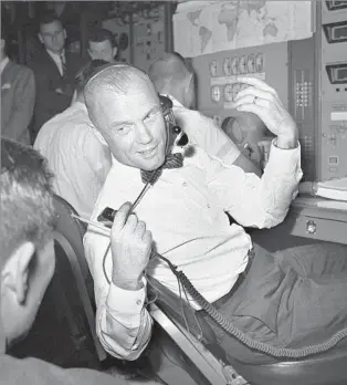  ?? Associated Press ?? WAR HERO AND TEST PILOT Glenn performs a test in the control room of the NASA tracking ship Coastal Sentry at Cape Canaveral, Fla., in May 1963. “He had supreme confidence in himself,” his biographer said.