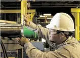  ?? Tenaris ?? A Tenaris worker inspects a pipe. The company has bought Houston’s IPSCO Tubulars, making it the largest steel pipe producer in North America.